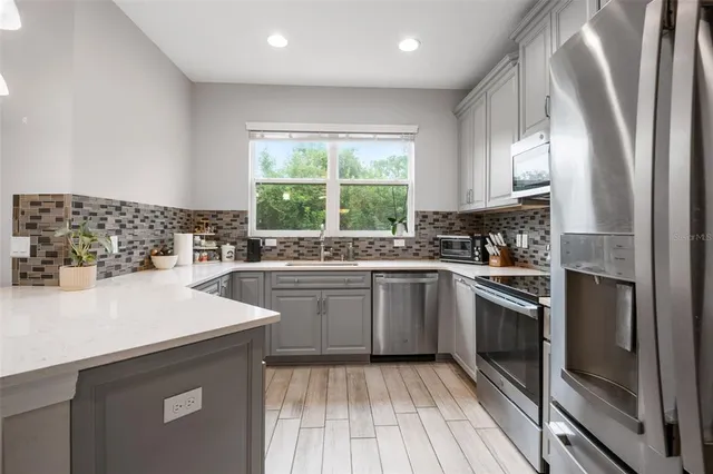 a kitchen with a sink stove and cabinets