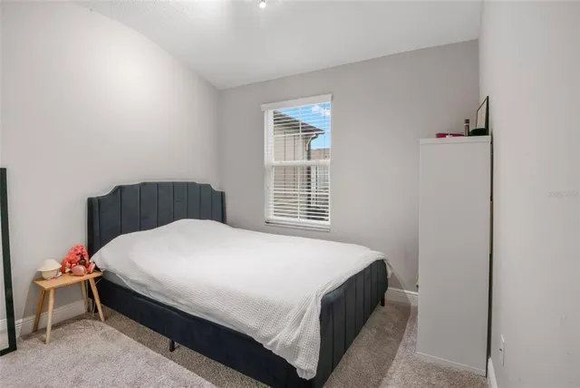 a bedroom with a bed and window