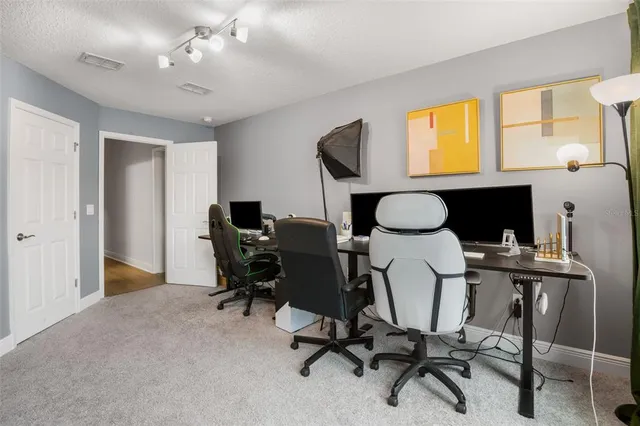 a view of a workspace with furniture and a window