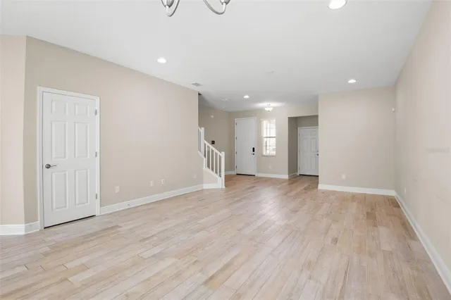 a view of an empty room with wooden floor