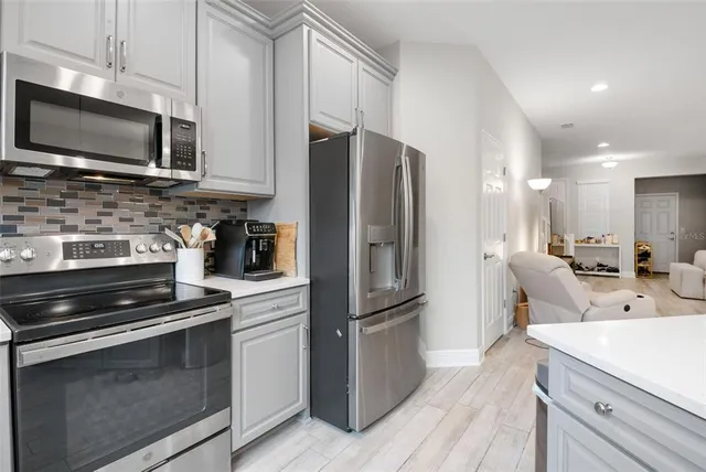 a kitchen with a refrigerator stove and microwave