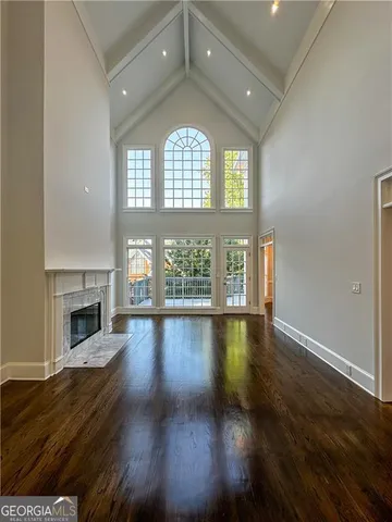 wooden floor in an empty room with a fireplace