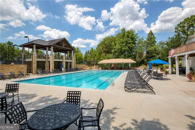 a view of a house with backyard porch and sitting area