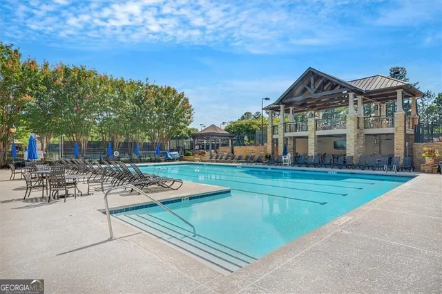 a view of a house with swimming pool and sitting area