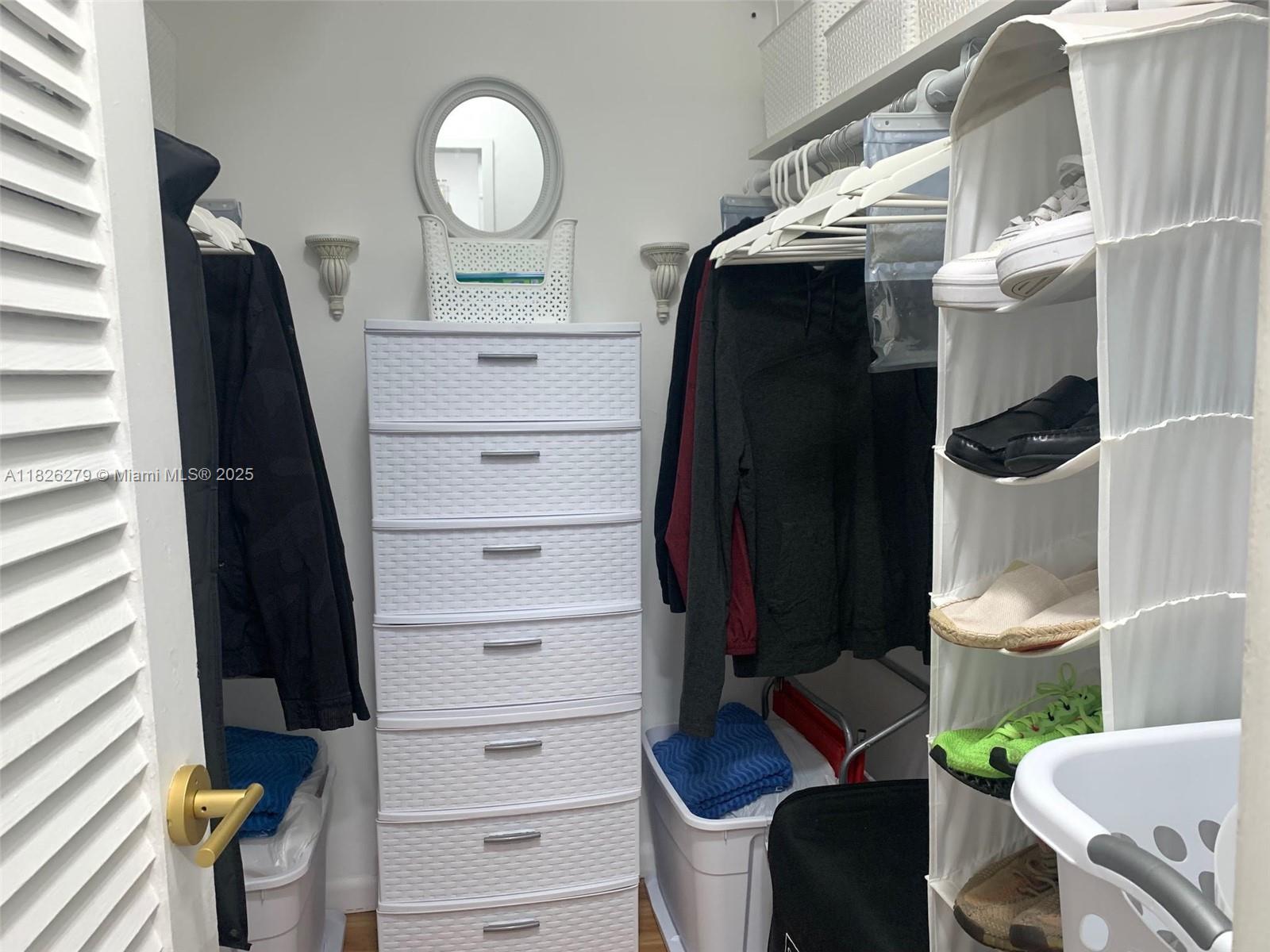 100 Lincoln Road, Unit 315 Miami Beach, FL 33139 - Photo 13 of 16 a view of walk in closet with clothes and shoes