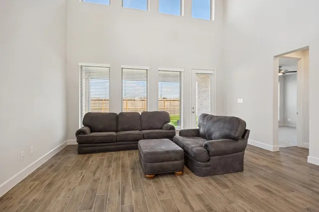 a living room with furniture and a wooden floor