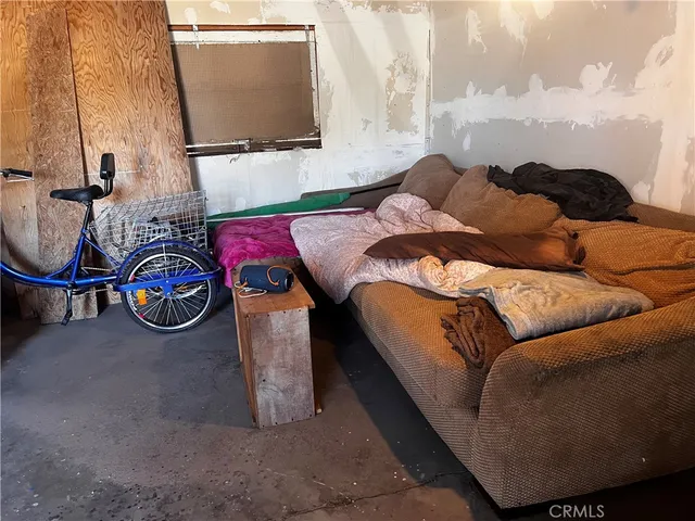 a view of a room with furniture and a mirror