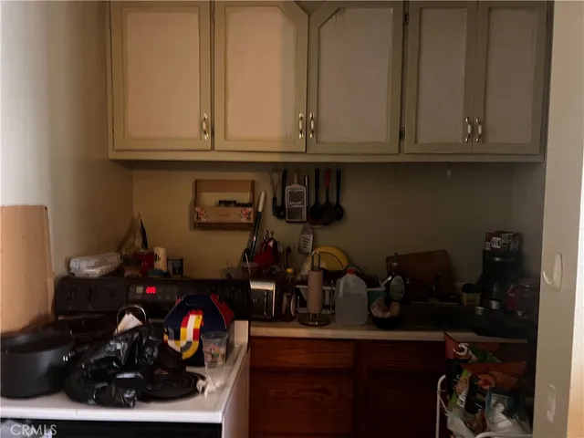 a kitchen with lots of bottles of alcohol