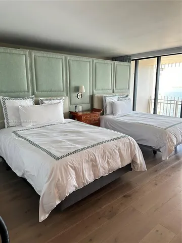 a view of a hallway with entryway wooden floor and windows