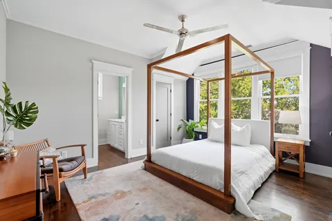 a bedroom with a bed and wooden floor