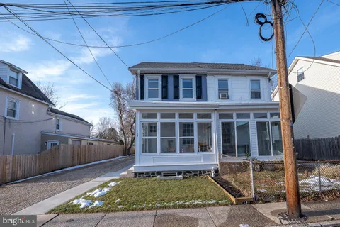 a view of a house with a small yard and wooden floor