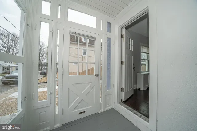a bathroom with a glass shower door and mirror