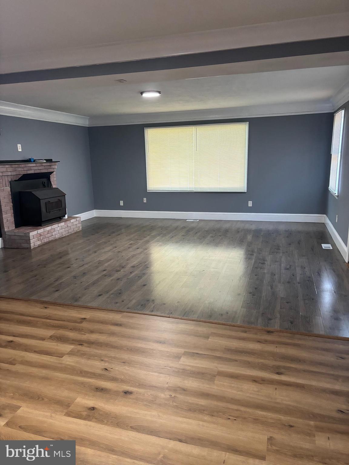 7283 Wellington Road Manassas, VA 20109 - Photo 2 of 11 a view of empty room with window and fireplace