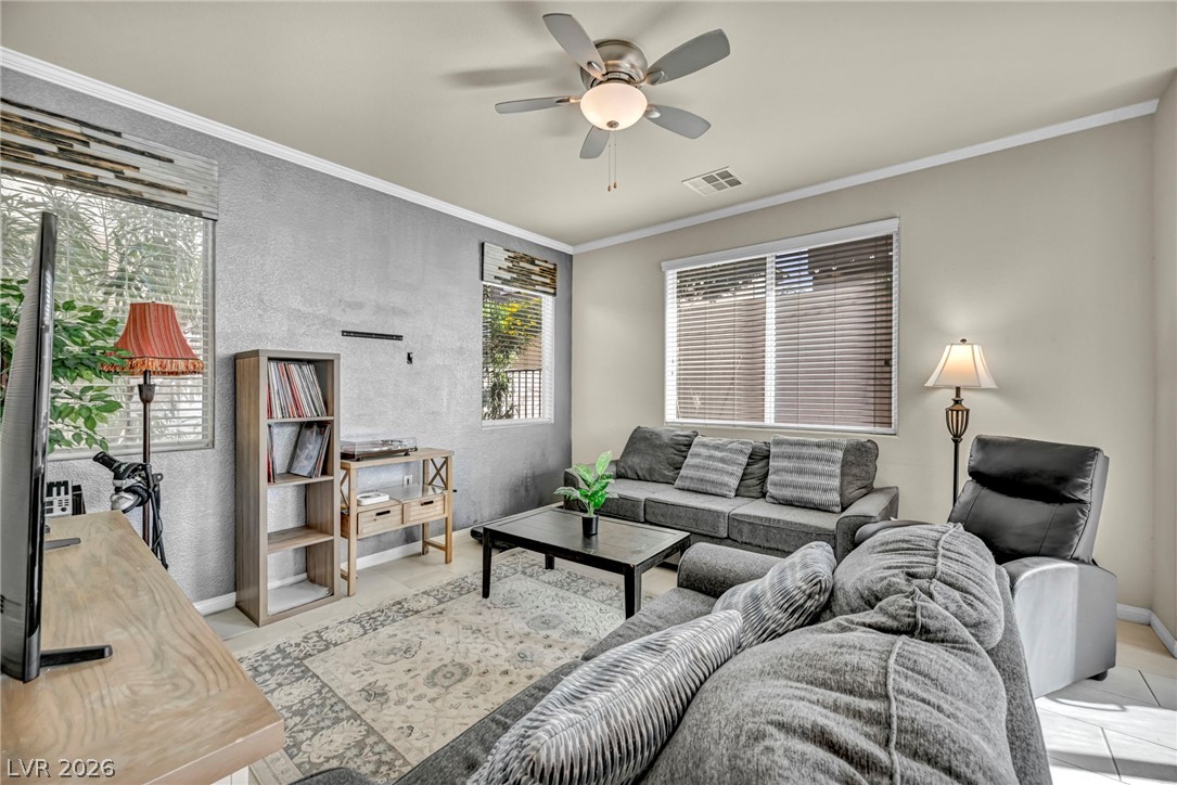 389 Fringe Ruff Drive Las Vegas, NV 89148 - Photo 6 of 53 Crown molding and large windows enhance this comfortable living space.