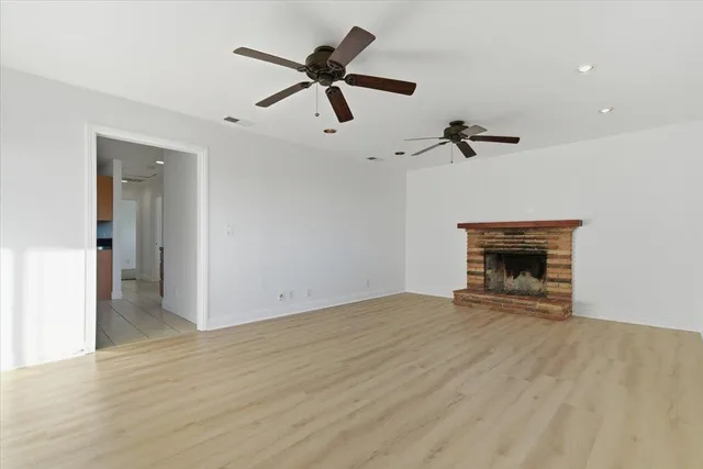 wooden floor in an empty room with a fireplace