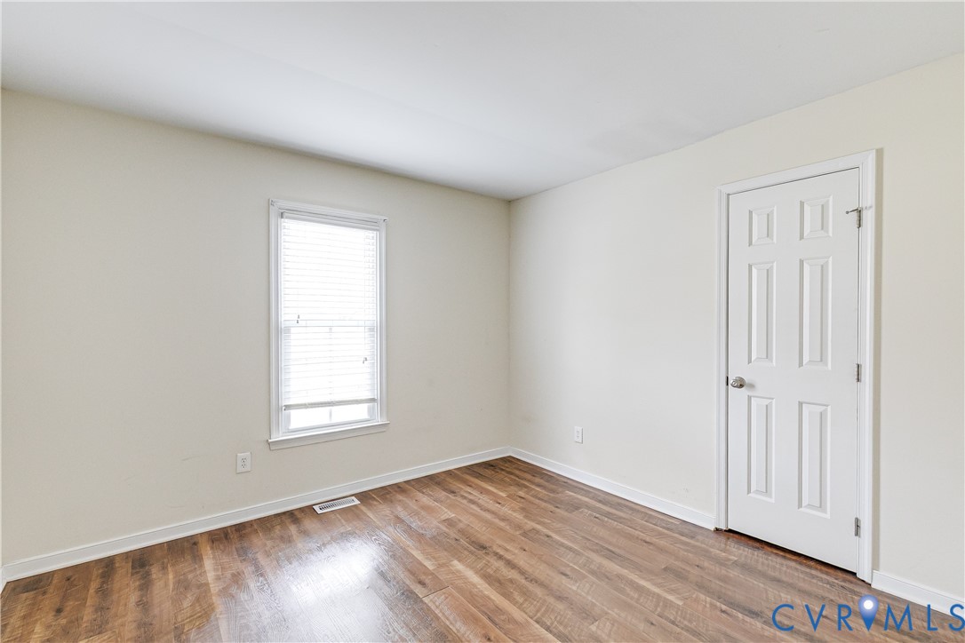 600 Queensway Road Chesterfield, VA 23236 - Photo 21 of 33 an empty room with wooden floor and windows