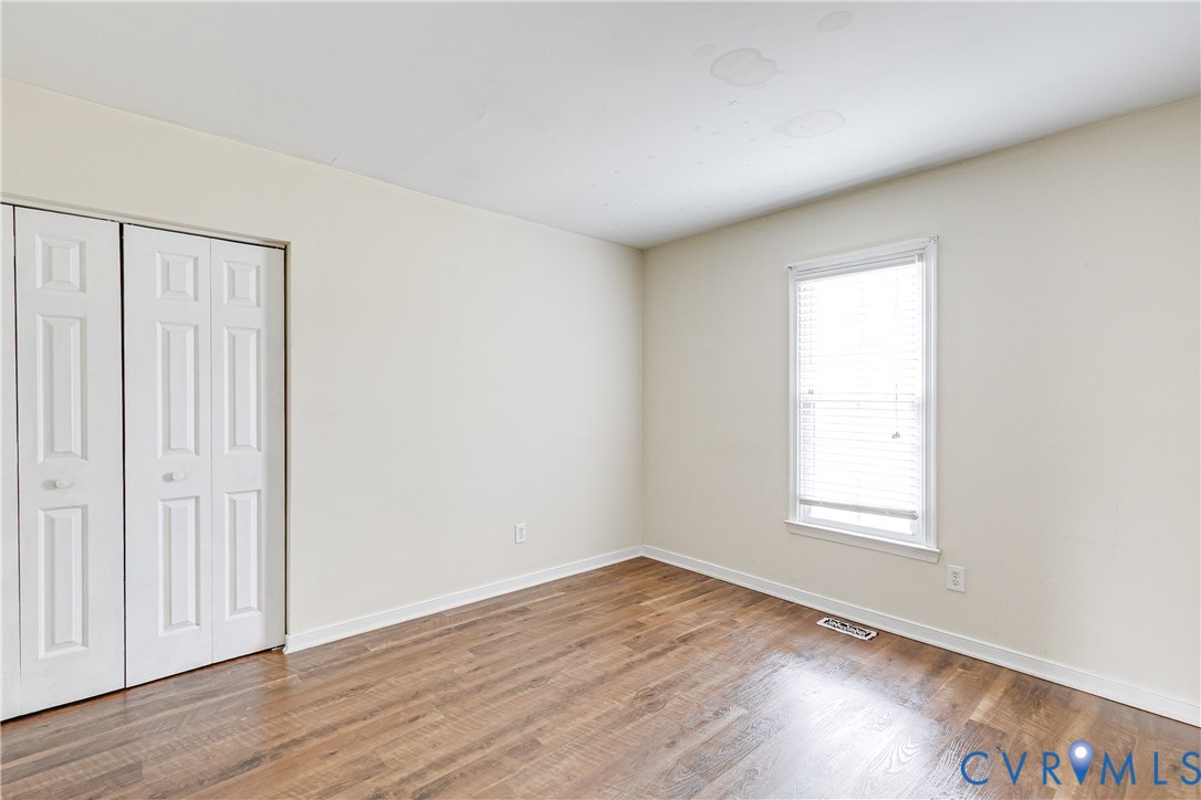 600 Queensway Road Chesterfield, VA 23236 - Photo 23 of 33 an empty room with wooden floor and windows