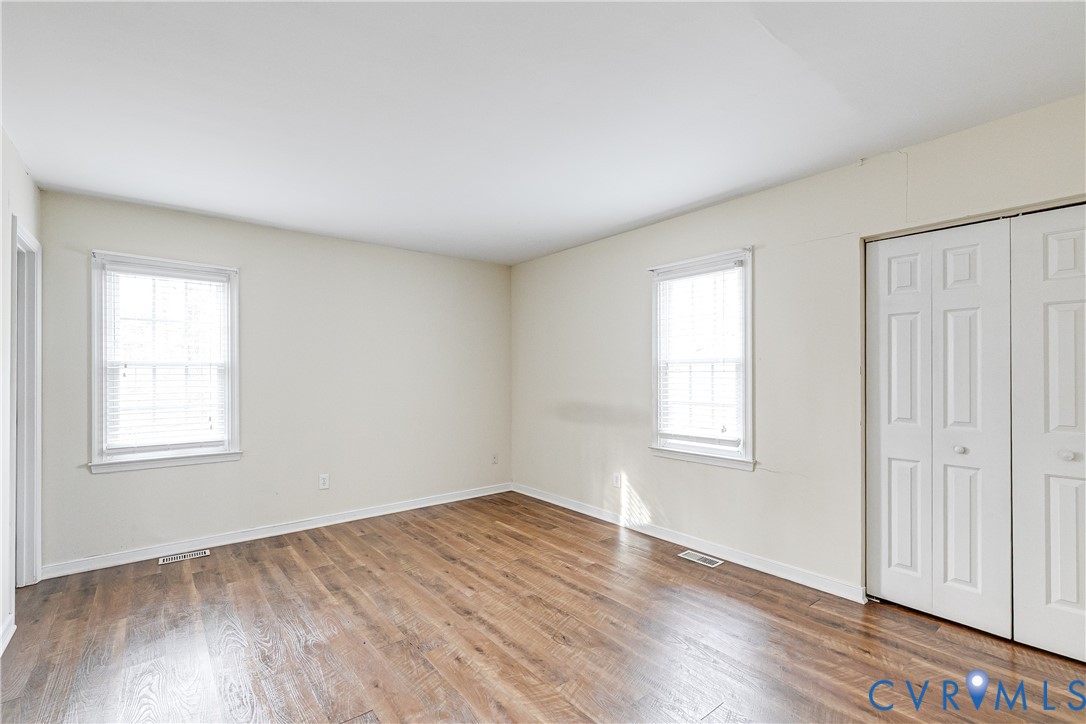 600 Queensway Road Chesterfield, VA 23236 - Photo 25 of 33 an empty room with wooden floor and windows
