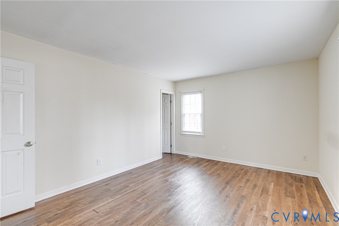 600 Queensway Road Chesterfield, VA 23236 - Photo 28 of 33 an empty room with wooden floor and windows