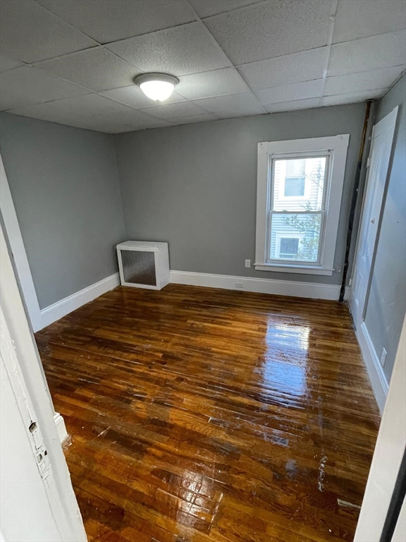 176 Broadway, Unit 2 Methuen, MA 01844 - Photo 2 of 8 a view of an empty room with wooden floor and a window