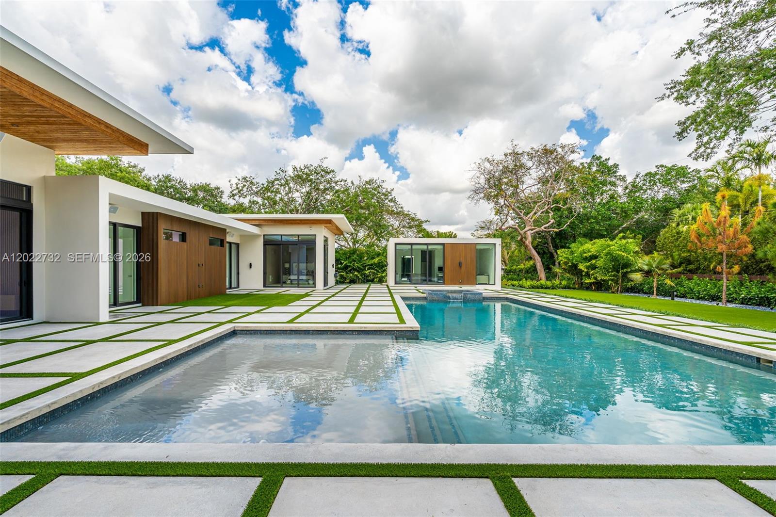 7825 Southwest 128th Street Pinecrest, FL 33156 - Photo 55 of 88 a view of a house with swimming pool and sitting area