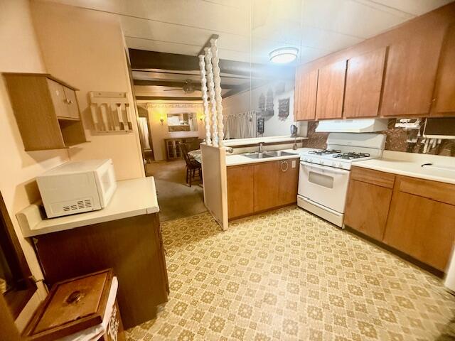 51555 Monroe Street Indio, CA 92201 - Photo 14 of 30 a kitchen with stainless steel appliances granite countertop a sink stove and refrigerator