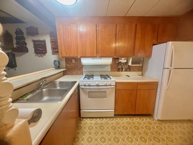 51555 Monroe Street Indio, CA 92201 - Photo 16 of 30 a kitchen with a sink stove and refrigerator