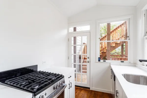 a kitchen with wooden floor and a window