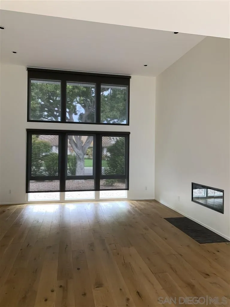 3921 Avenida Brisa Rancho Santa Fe, CA 92091 - Photo 4 of 9 a view of an empty room with wooden floor and a window