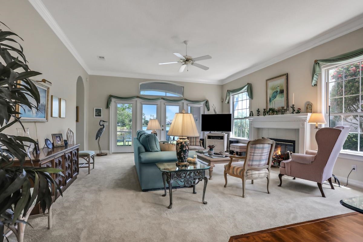 904 Birdie Way St. Augustine, FL 32080 - Photo 4 of 21 a living room with furniture a fireplace and a flat screen tv