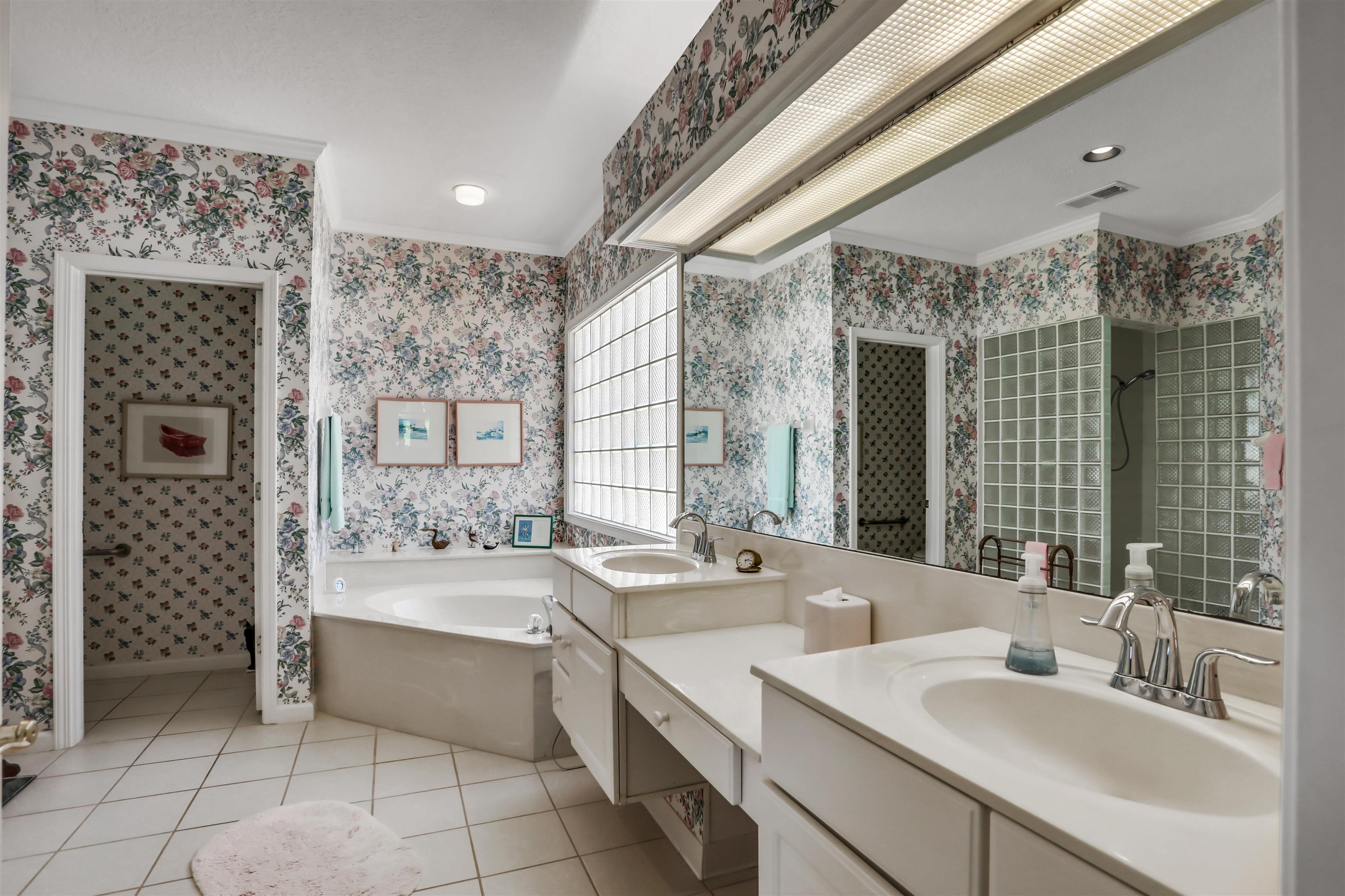 904 Birdie Way St. Augustine, FL 32080 - Photo 10 of 21 a bathroom with a double vanity sink mirror and shower