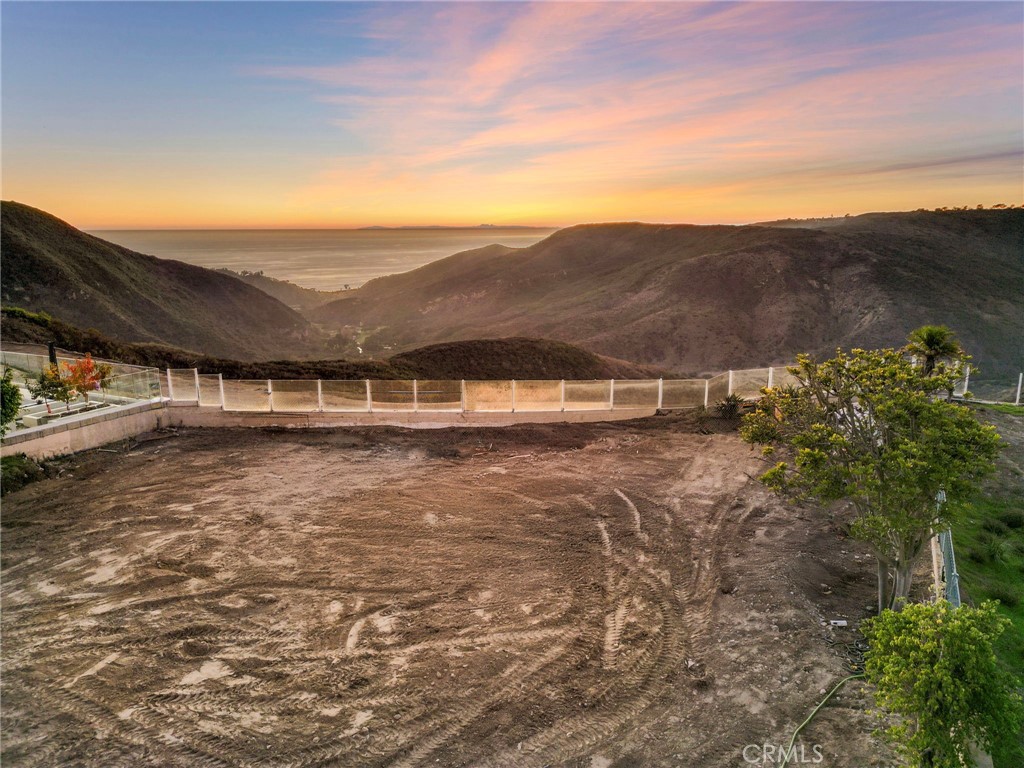 a view of swimming pool and mountains in the background