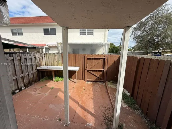 a view of living room kitchen with furniture and wooden deck