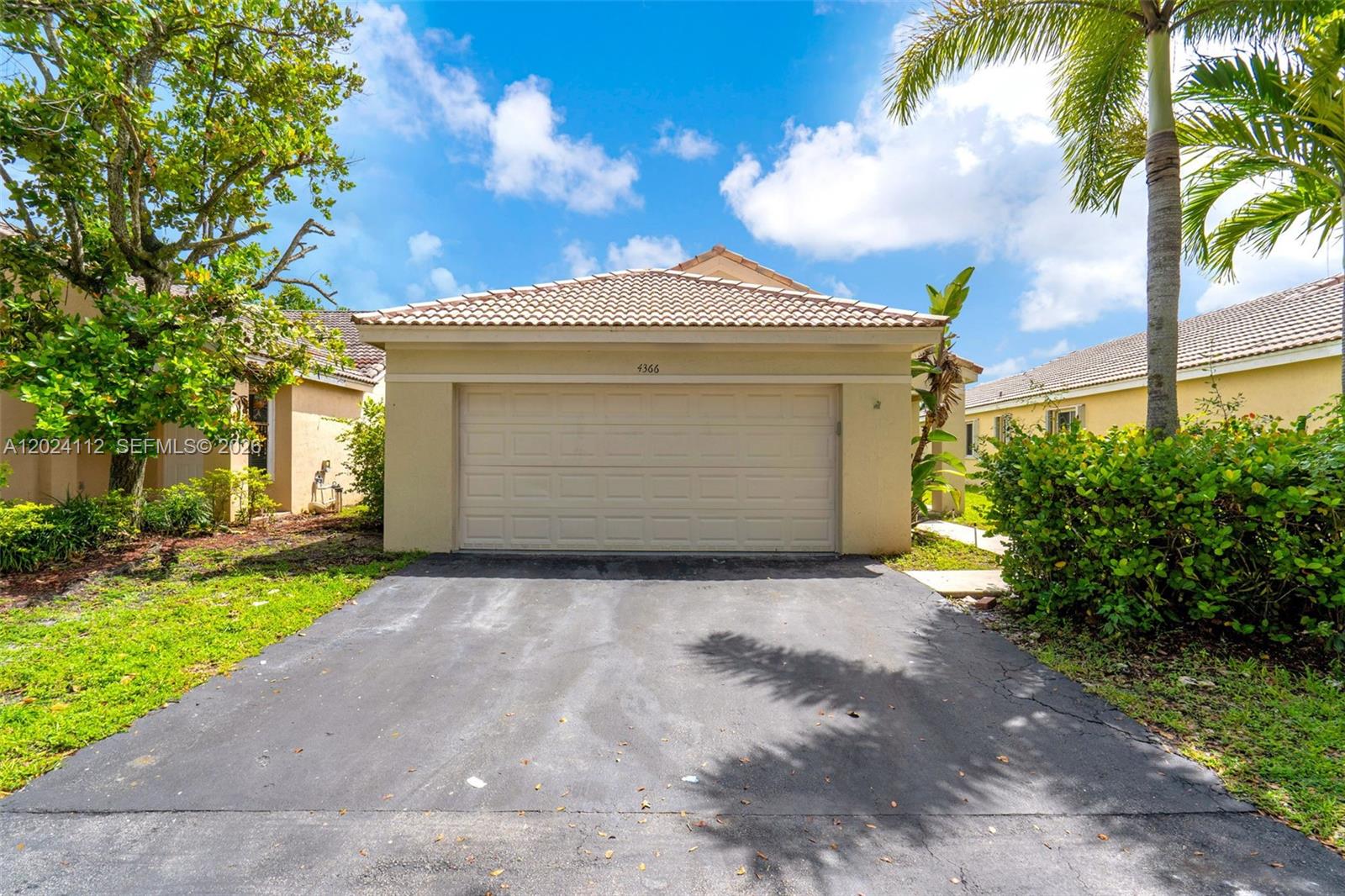 4366 Mahogany Ridge Drive Weston, FL 33331 - Photo 1 of 41 a front view of a house with a yard and garage