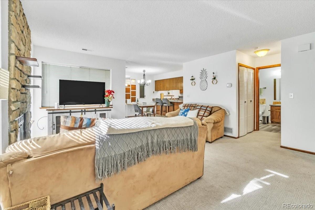 9142 West 88th Circle Westminster, CO 80021 - Photo 2 of 12 a living room with furniture and a flat screen tv