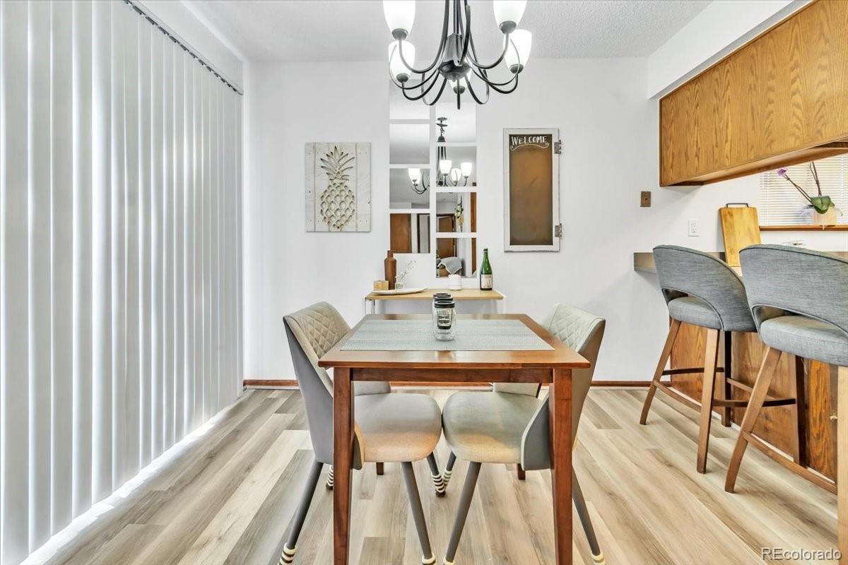9142 West 88th Circle Westminster, CO 80021 - Photo 3 of 12 a view of a dining room with furniture window and wooden floor