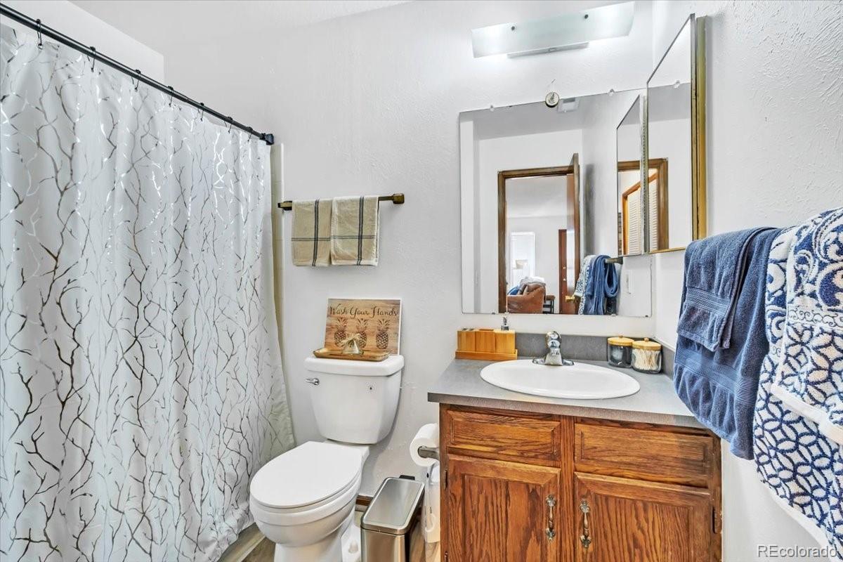9142 West 88th Circle Westminster, CO 80021 - Photo 6 of 12 a bathroom with a toilet sink and mirror