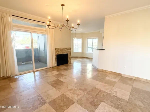 a view of an empty room with a fireplace and a window
