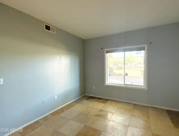 a view of a big room with wooden floor and a cabinet