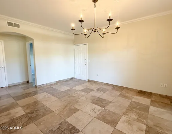 a view of a room with a chandelier fan and windows