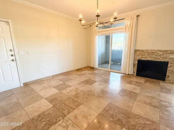 a view of a big room with a fireplace and entryway