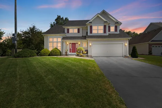 a front view of a house with a yard and garage