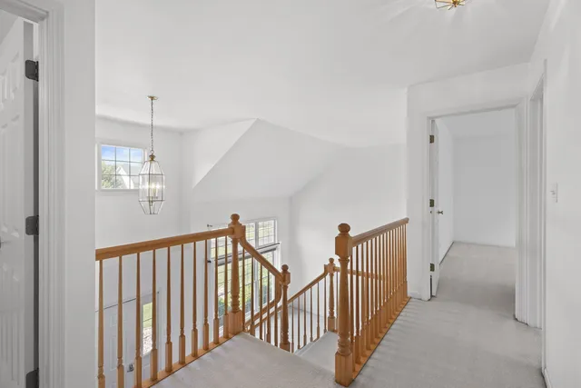 a view of a hallway with windows and stairs
