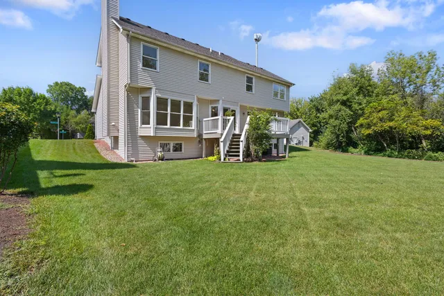 a view of house with backyard