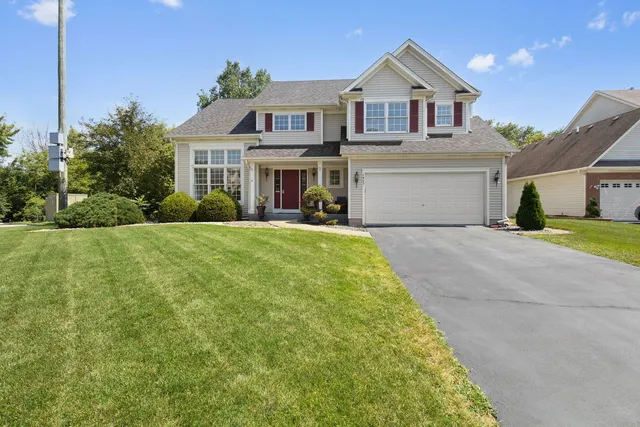 a front view of house with yard and green space
