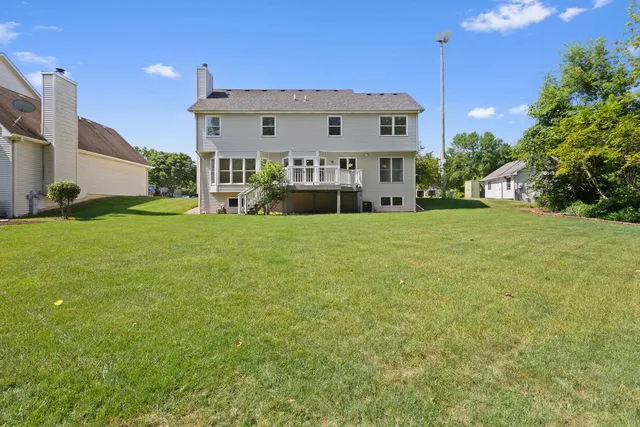 a view of a house with a big yard and potted plants