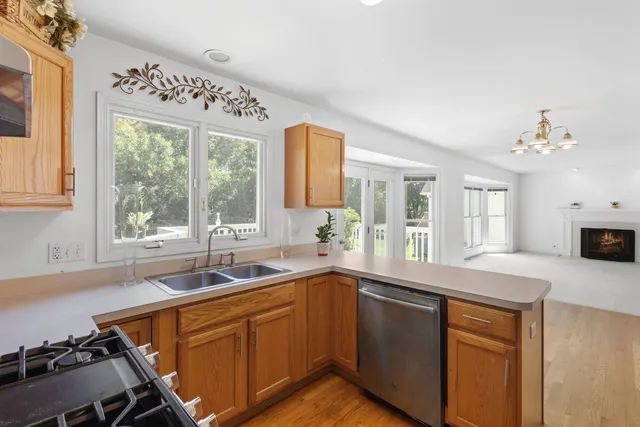 a kitchen with a sink window and cabinets