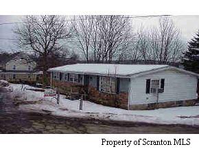 a backyard of a house with yard and outdoor seating
