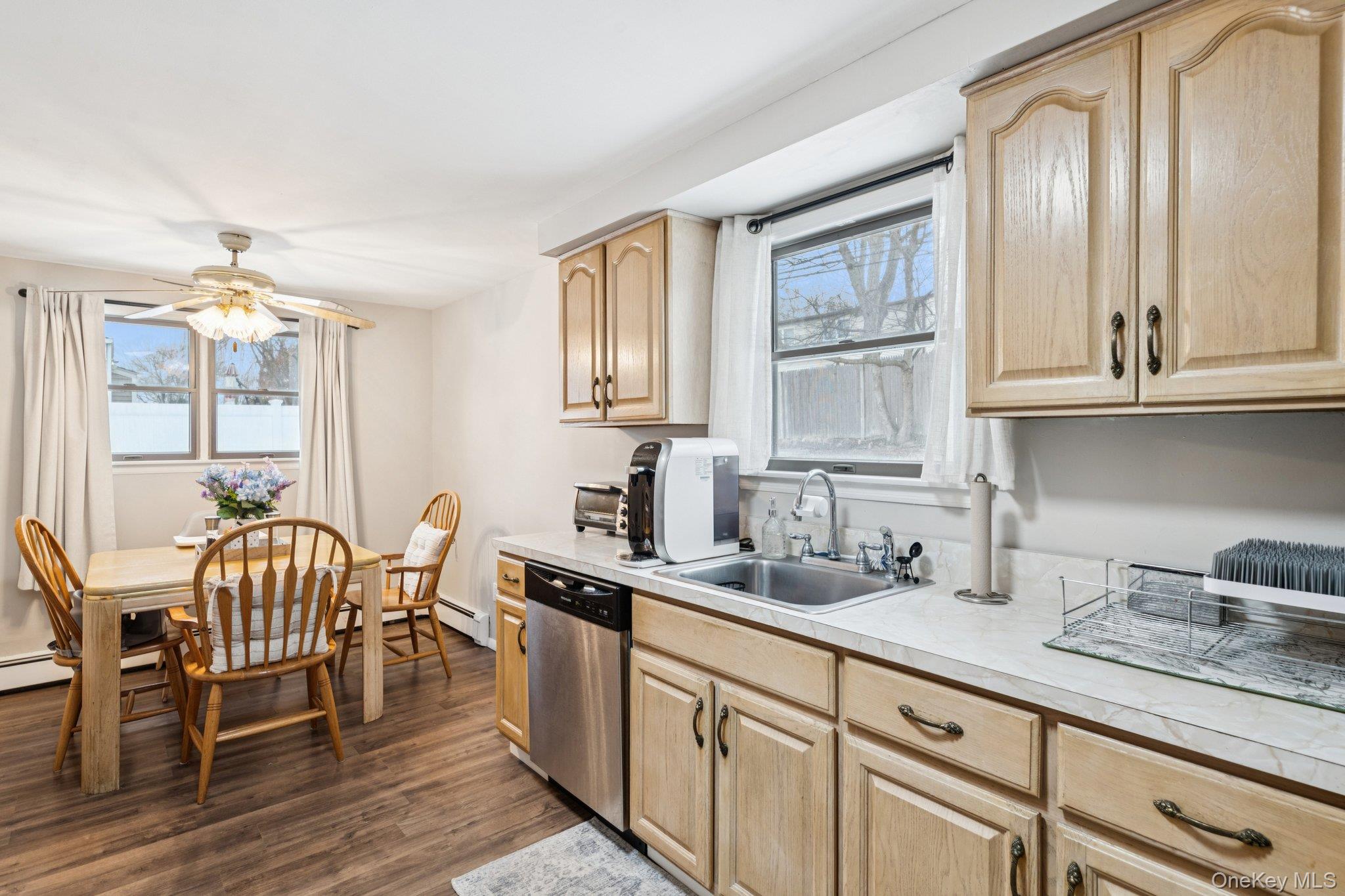 25 Wilson Street Centereach, NY 11720 - Photo 11 of 27 a kitchen with granite countertop a sink cabinets and dining table