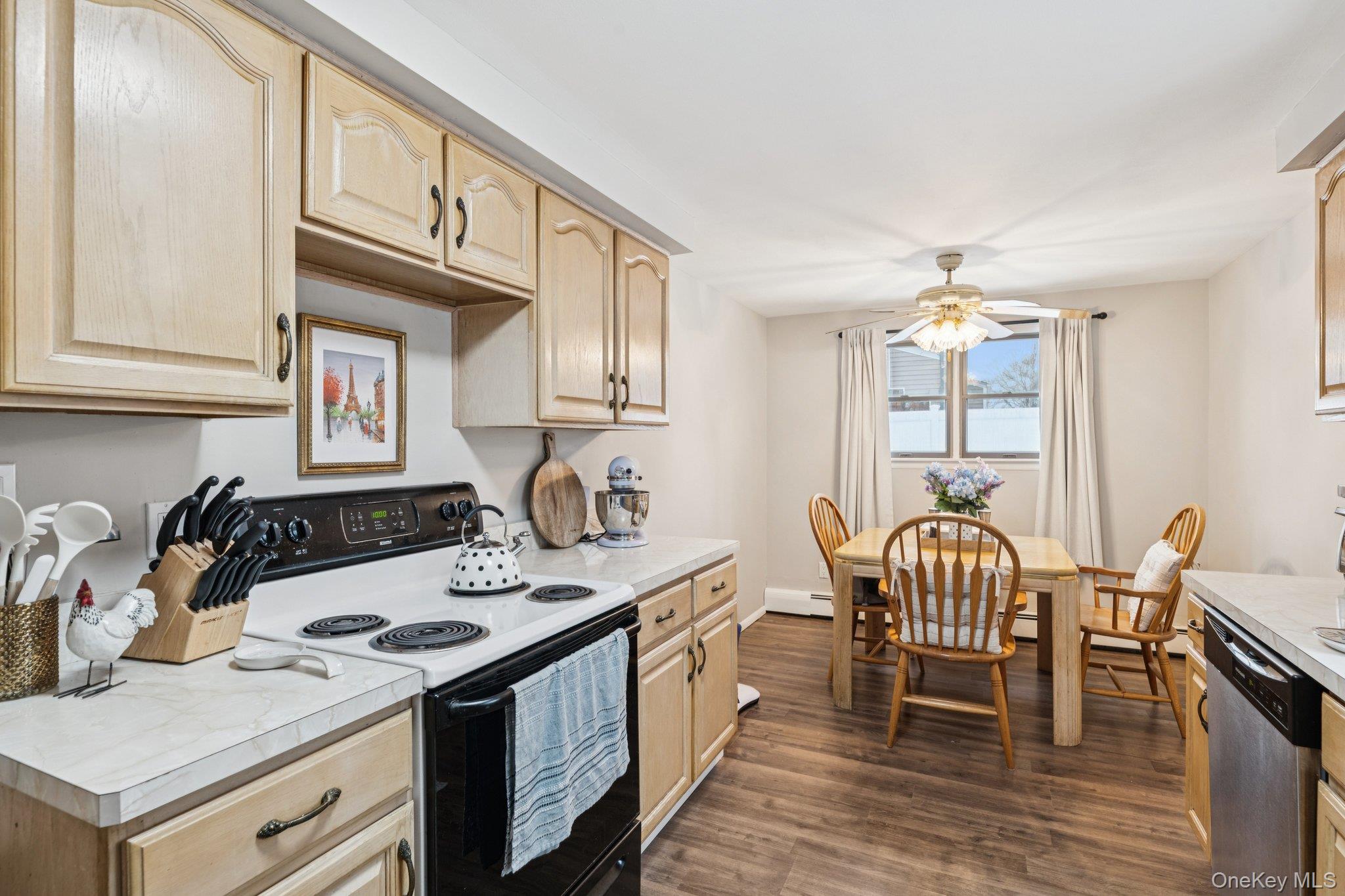 25 Wilson Street Centereach, NY 11720 - Photo 12 of 27 a kitchen with granite countertop a stove a sink a dining table and chairs
